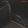Close-up of a black Feather Light 18 Wheelchair with orange trim on a dark background. The word Feather appears in orange at the top right, showcasing the wheelchairs sleek and modern style.
