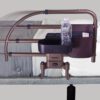 The Freedom Click Extendable Bed Rail, shown on a white-sheeted bed with a gray mattress, holds a bottle of water and phone in its caddy. Its displayed in both extended and collapsed positions to demonstrate its adjustability.