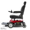 A side view of the Jazzy Elite ES, a red and black electric wheelchair featuring a padded seat and backrest, armrests, joystick control, extended footrest, and visible wheels. Text reads: FDA Class II Medical Device.