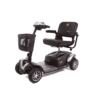 The Golden 4 Wheel Buzzaround EX, featuring a black and gray design, padded seat with armrests, steering handle, and front basket, is shown parked on a plain white background.