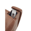 A Golden Technologies®️ Titan PR 448, a brown leather armchair featuring a hidden armrest compartment, is shown with a smartphone partially visible inside displaying a shopping website.