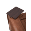 A close-up of the Golden Technologies®️ Titan PR 448 recliner armrest showcases a rectangular dark wood tray attached horizontally atop the brown leather surface.