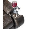 A glass of red wine rests in a detachable metal cup holder on the armrest of the Golden Technologies®️ Titan PR 448 brown leather sofa, showcasing visible stitching and an integrated stainless steel cup holder.