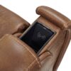Close-up of the Golden Technologies®️ Titan with Twilight PR 449 recliners brown leather armrest featuring a built-in wireless charging pad in a minimalist and functional compartment.