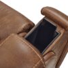 The Golden Technologies®️ Titan with Twilight PR 449 recliner features a brown leather armrest with an open compartment for a smartphone, showcasing a sleek, modern design and well-defined stitching.