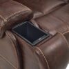 Close-up of the Golden Technologies®️ Titan with Twilight PR 449 recliners brown leather armrest featuring a built-in black cup holder, with visible stitching adding texture to the upholstered surface.