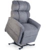 The Gray Golden Technologies®️ Comforter PR 531 is a fabric reclining chair with a padded headrest and armrests, partially elevated on a metal base, featuring a lift mechanism for easy access and comfort.