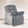 The Golden Technologies®️ Cloud with Twilight PR 515, a plush gray recliner with padded armrests and backrest, sits on a light wooden floor. Angled slightly to the right, its soft fabric upholstery creates a cozy look against a plain background.