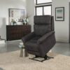A modern living room showcases the Pride VivaLift!® Urbana 2 Recliner Chair in gray on a beige rug, complemented by a dark wood sideboard. Two framed pictures adorn the wall, and natural light through the windows enhances the contemporary decor.