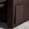 Close-up of the Golden Technologies® Cloud+ Power Lift Recliner PR 511, featuring brown leather and a wooden side panel, on a patterned rug.