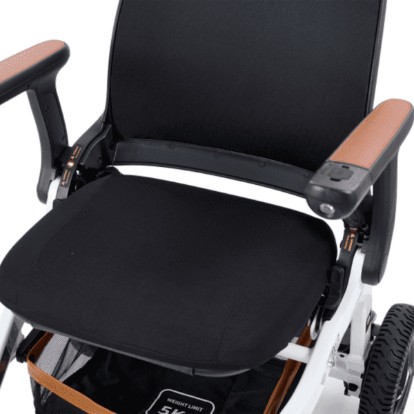 The image showcases the Golden Ally Power Wheelchair with a sleek black seat, brown-topped armrests, and a white frame. Visible wheels and intricate mechanisms underneath highlight its functionality and style.