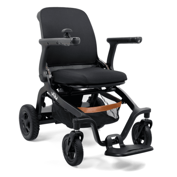 The Golden Ally Power Wheelchair is a modern, black electric model featuring a cushioned seat, armrests, and joystick on the right. It has small front wheels, larger rear wheels, and a mesh storage compartment beneath the seat.