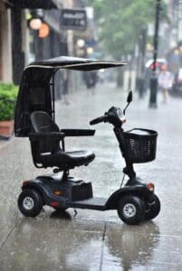 Mobility scooter on the sidewalk during rain.