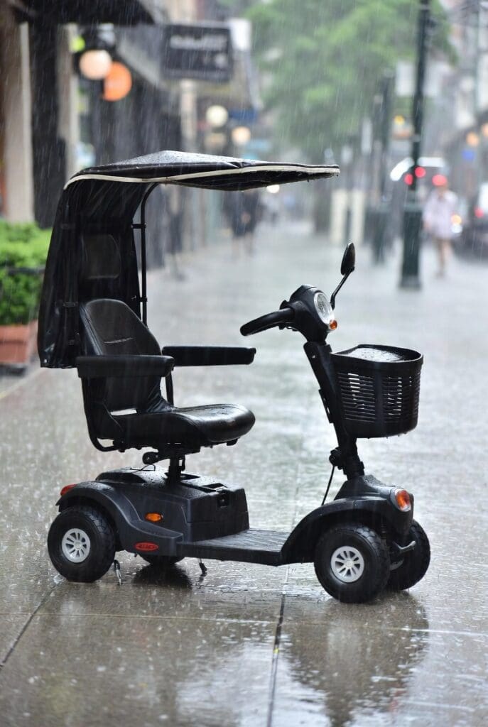 Mobility scooter on the sidewalk during rain.